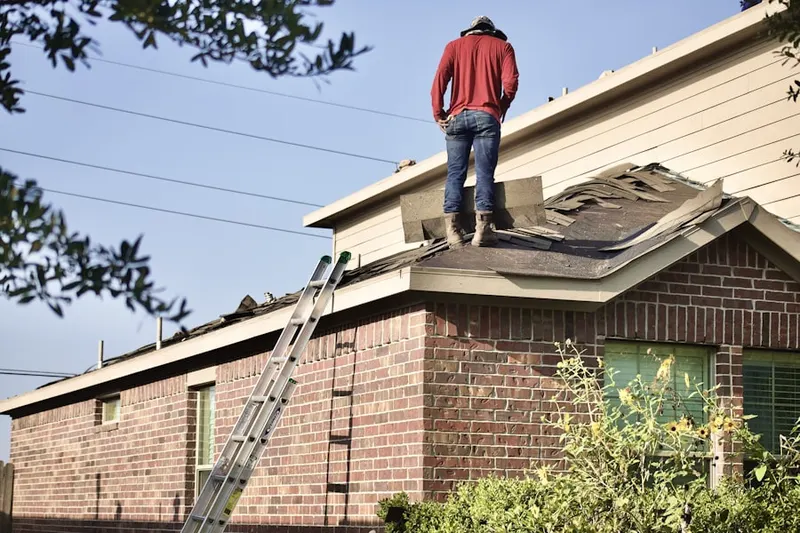 Professional roofer working on a residential roof in Montecito